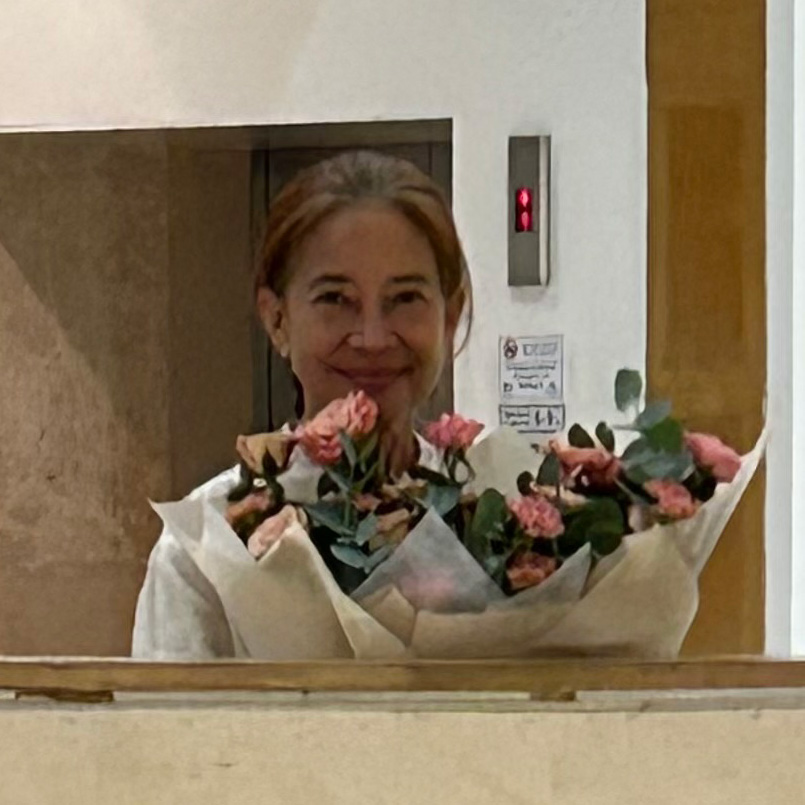 woman holding pink bouquet of flowers