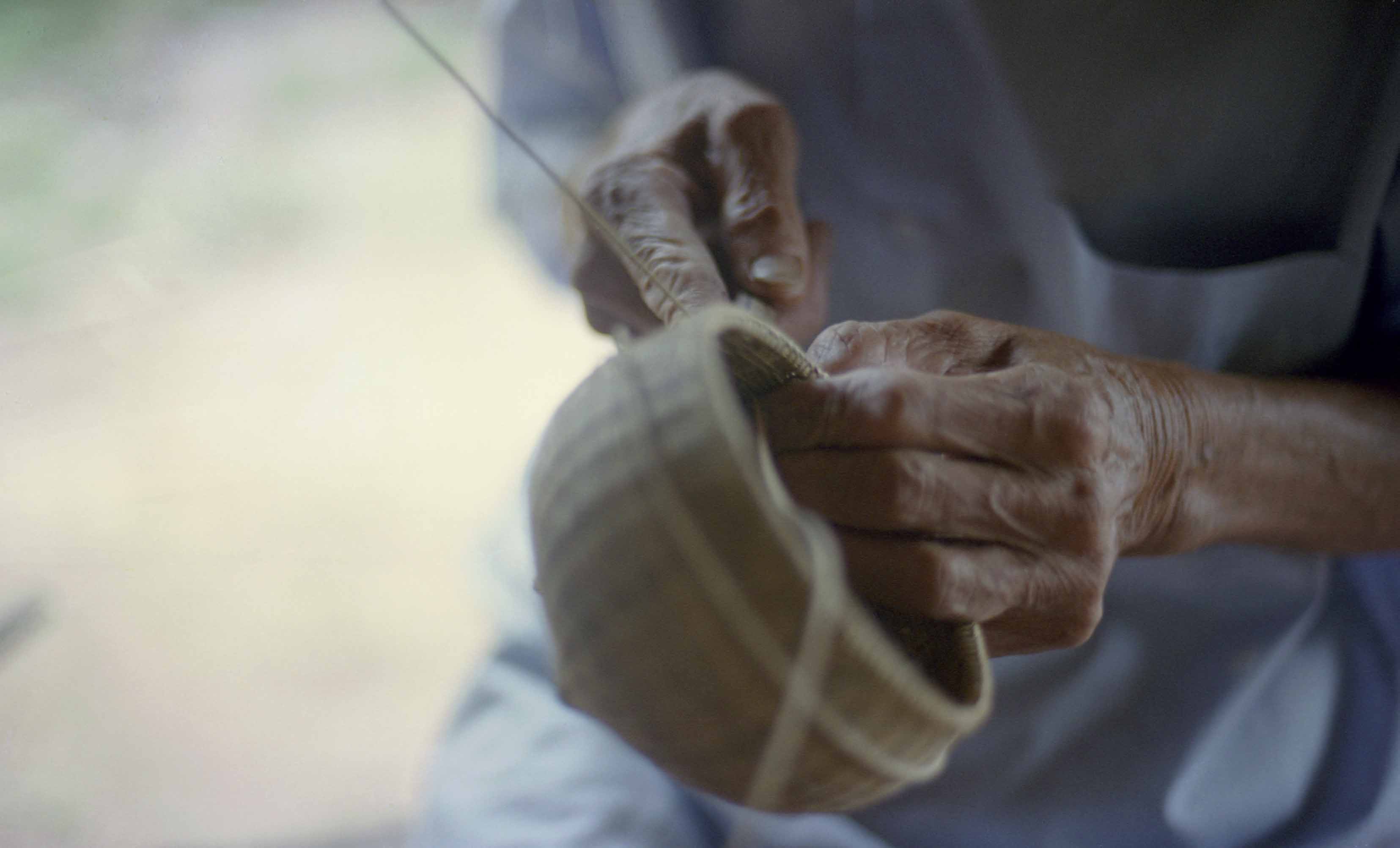 man weaving at Womanifesto Workshop 2001 shot of hands
