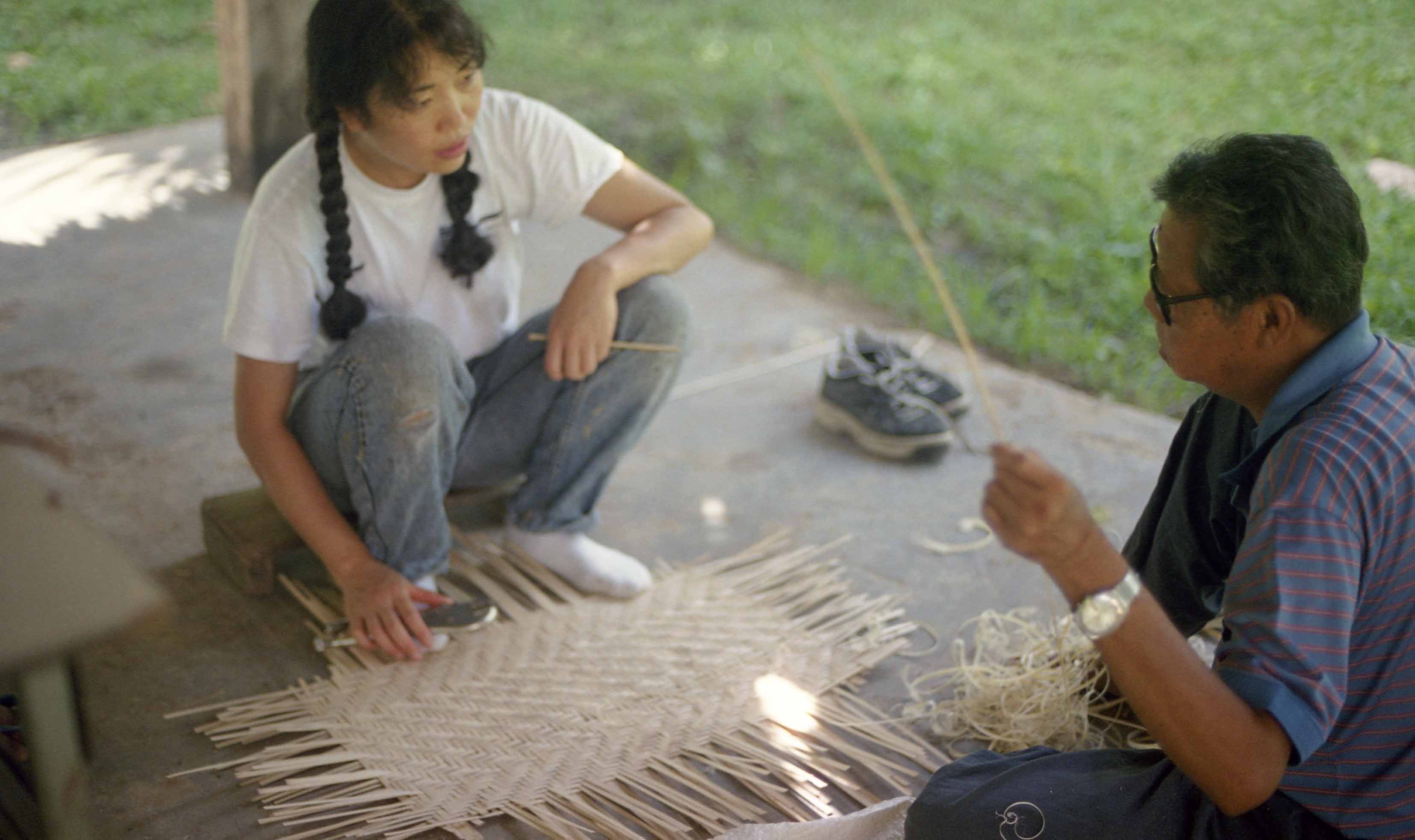 woman and man weaving a mat at womanifesto workshop 2001