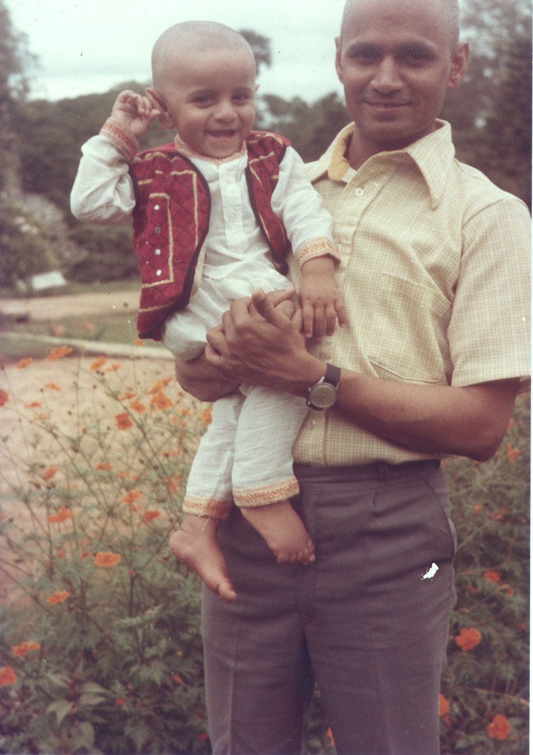 'A Baby Wearing Light Cotton Kurta, Pyjama and Colourful Embroidered Jacket'